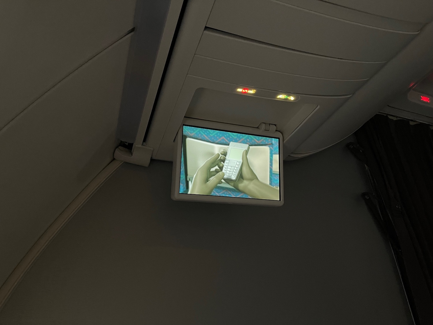 a tv on the ceiling of a plane
