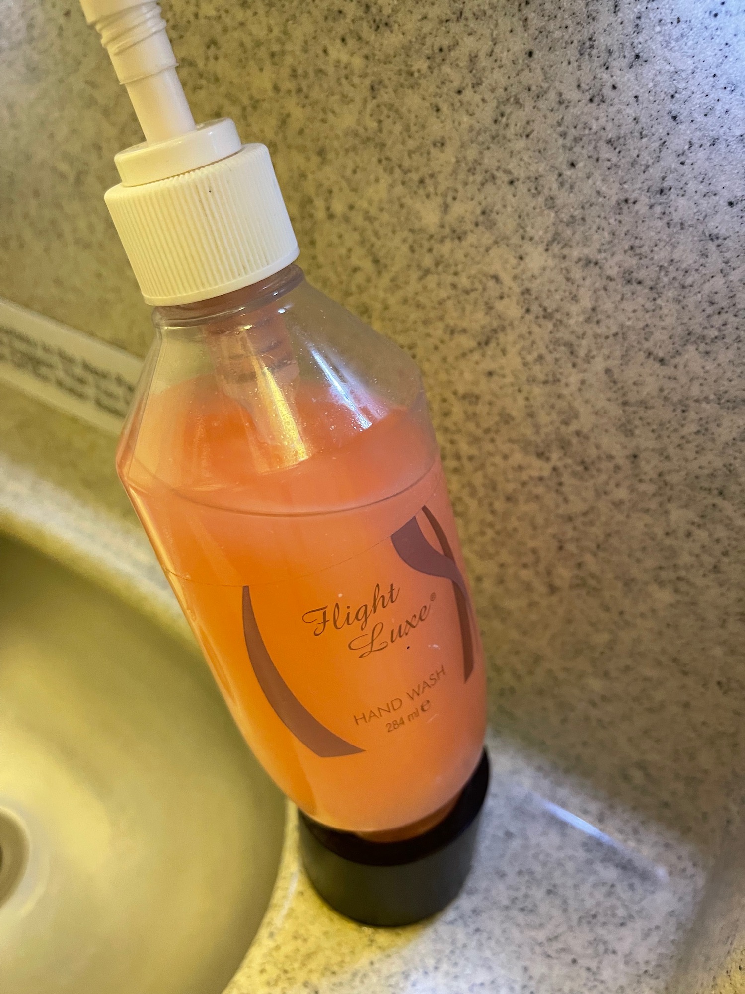 a bottle of liquid on a sink