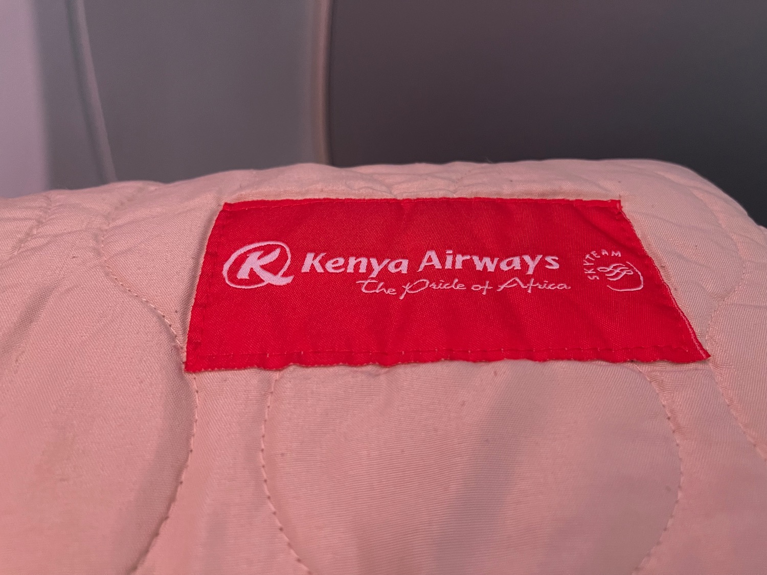 a red label on a pink blanket