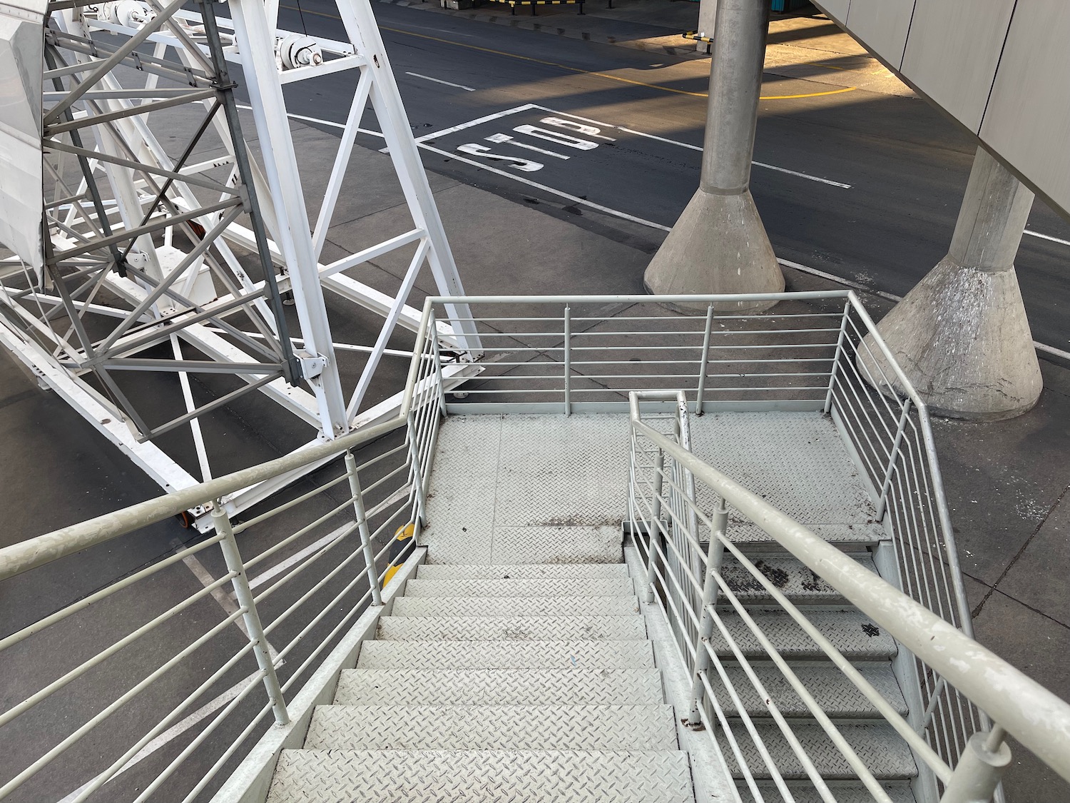 a metal stairs with railings and a street in the background