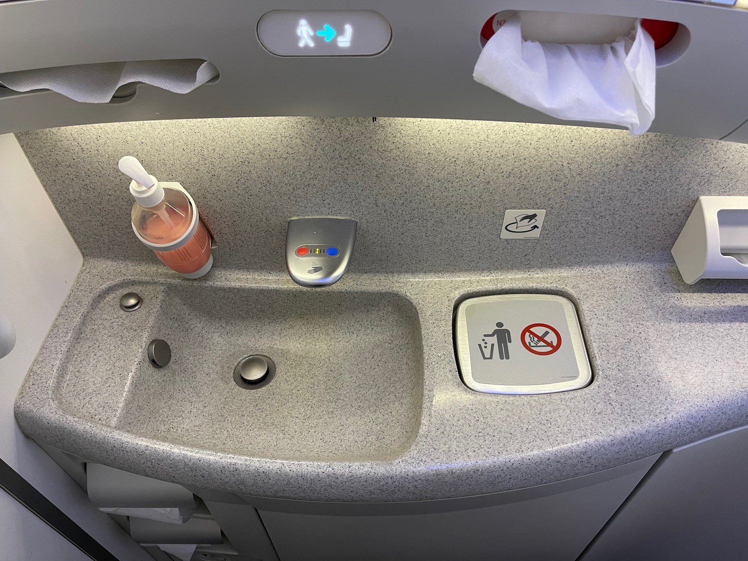 a sink with a bottle of liquid in it