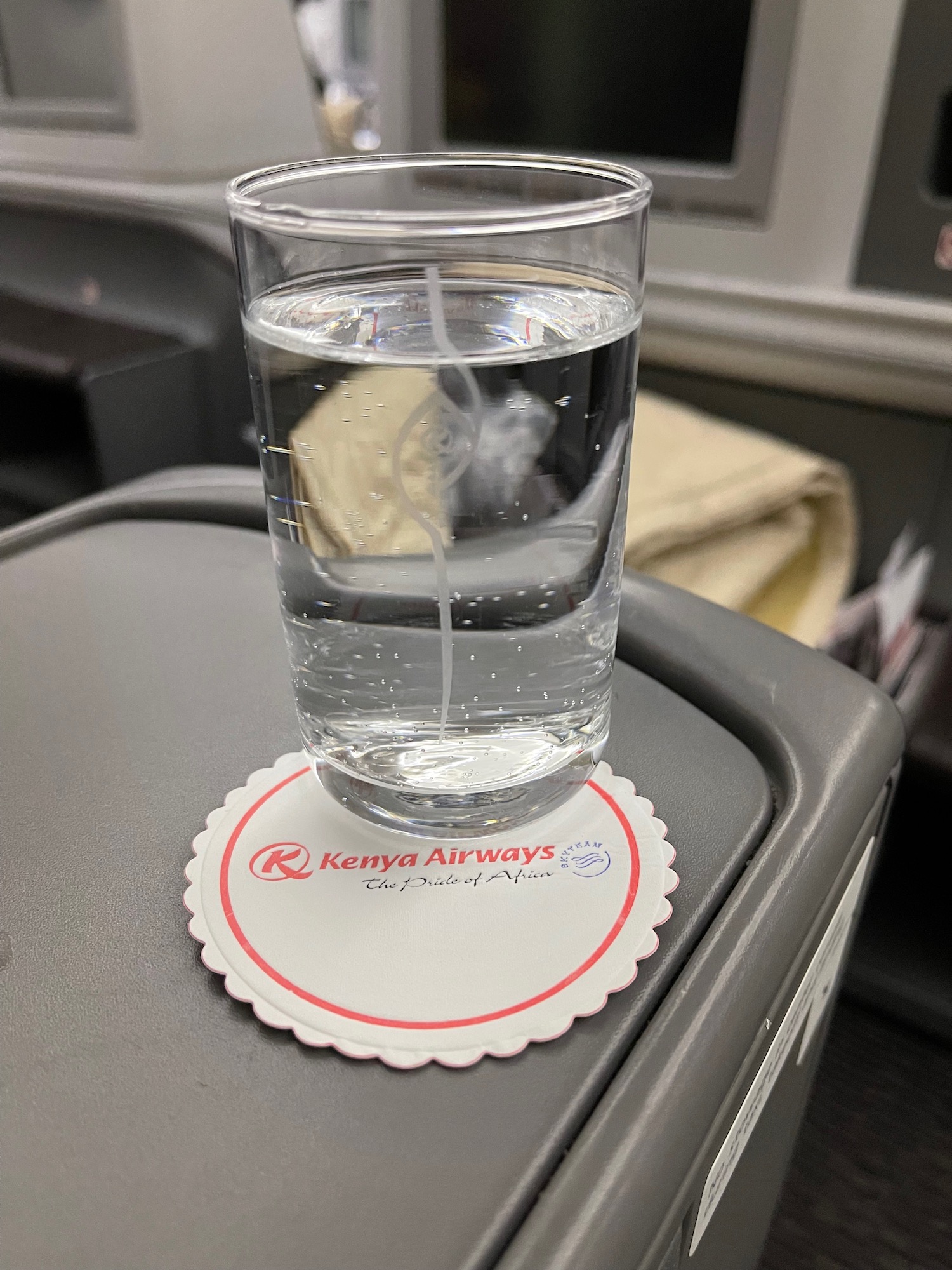 a glass of water on a coaster