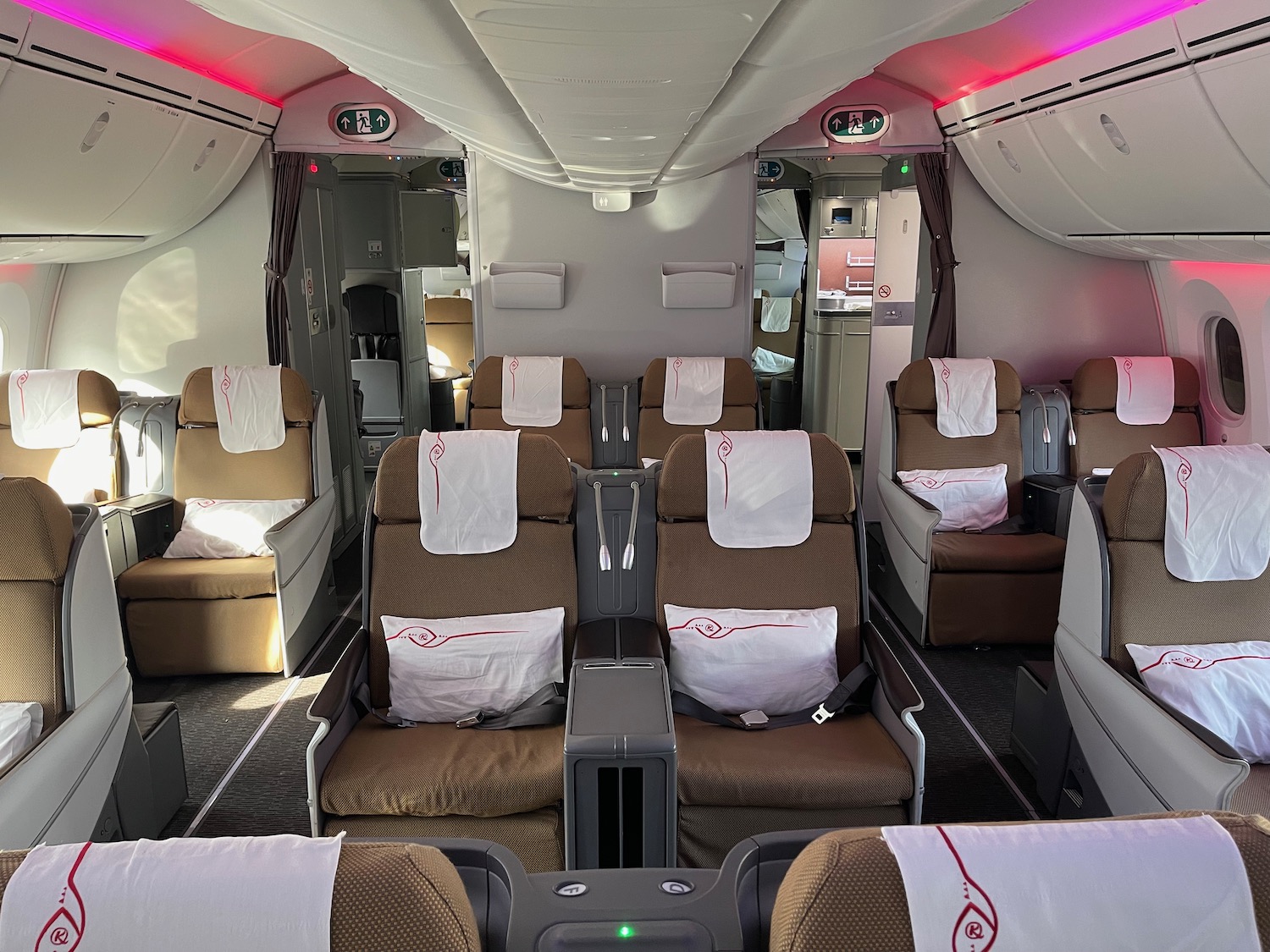 the inside of an airplane with seats and red lights