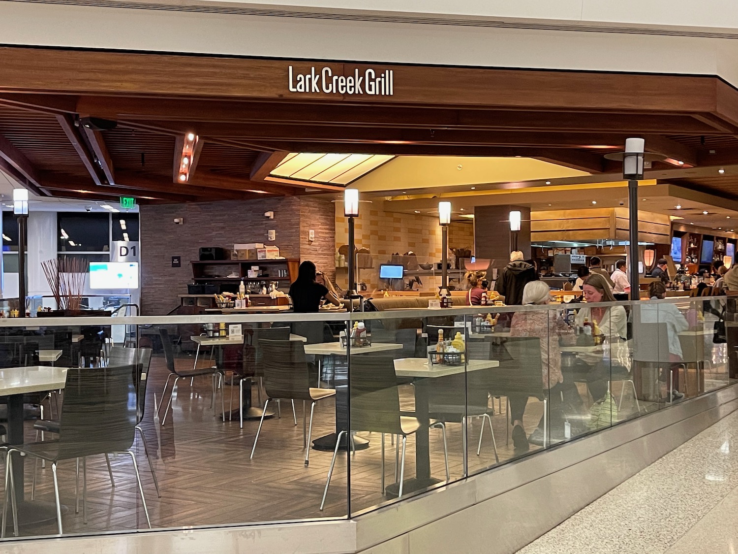 a group of people sitting at tables in a restaurant