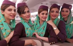 a group of women wearing purple hats and matching headscarves