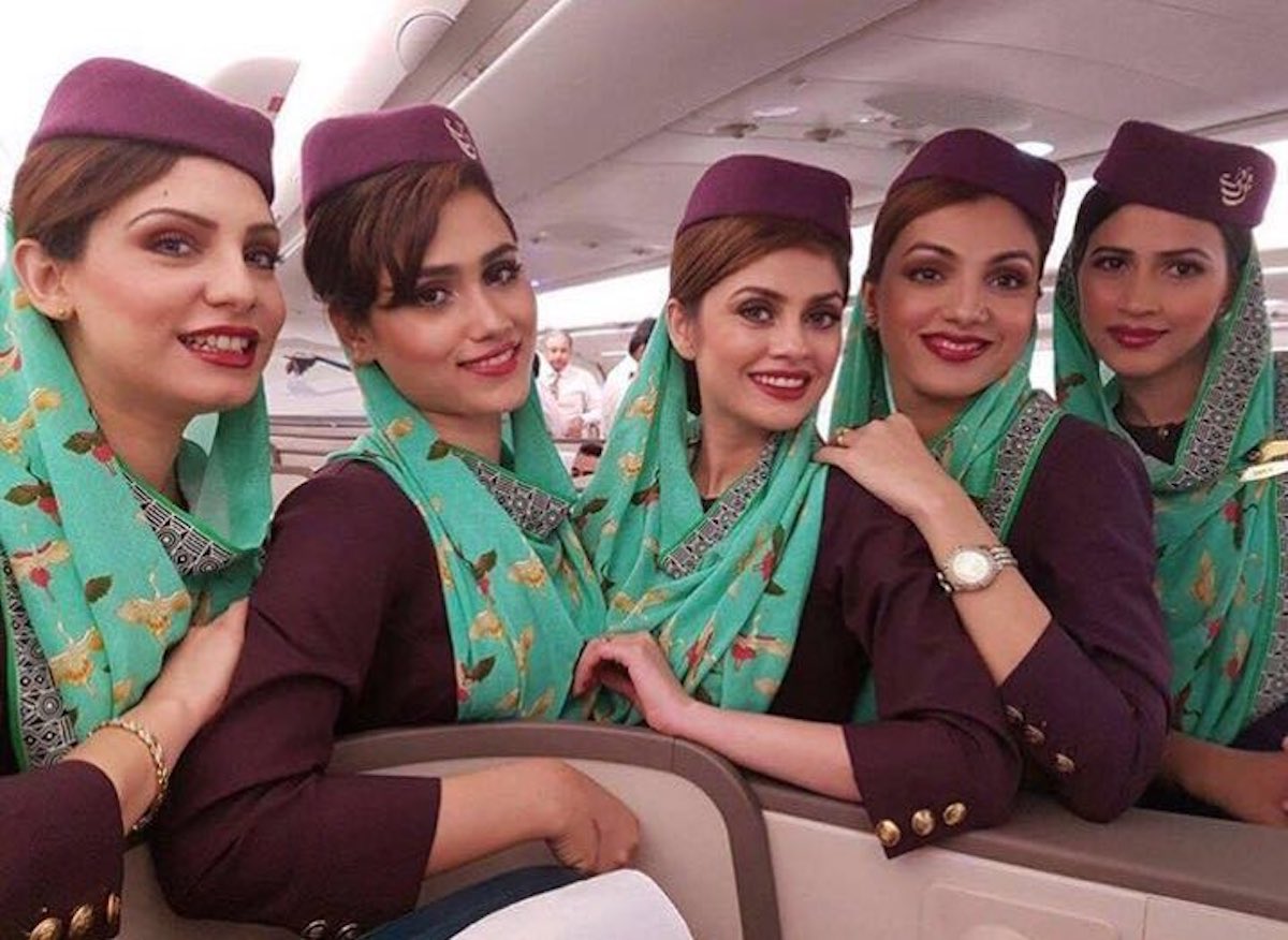 a group of women wearing purple hats and matching headscarves