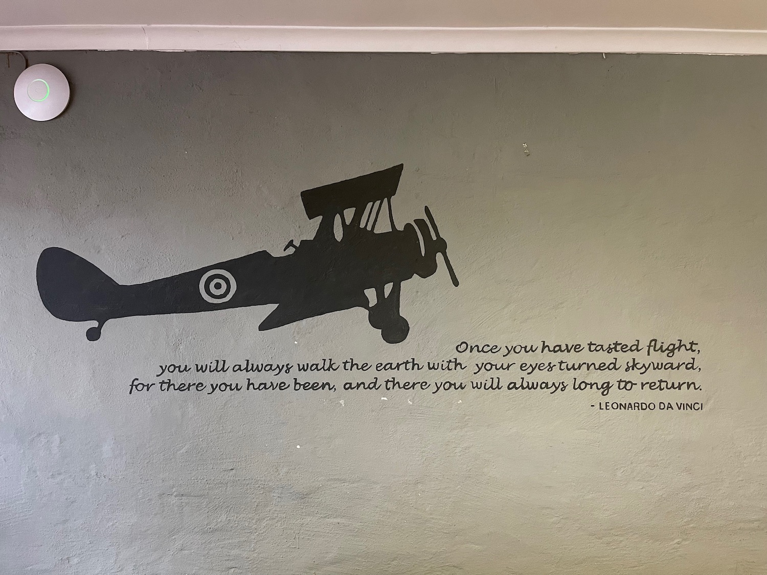 a wall with a drawing of a plane and text