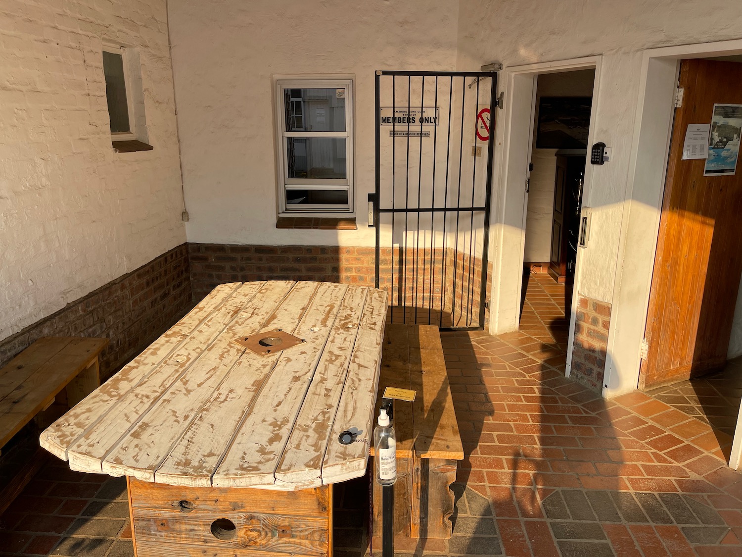 a wooden table in a courtyard