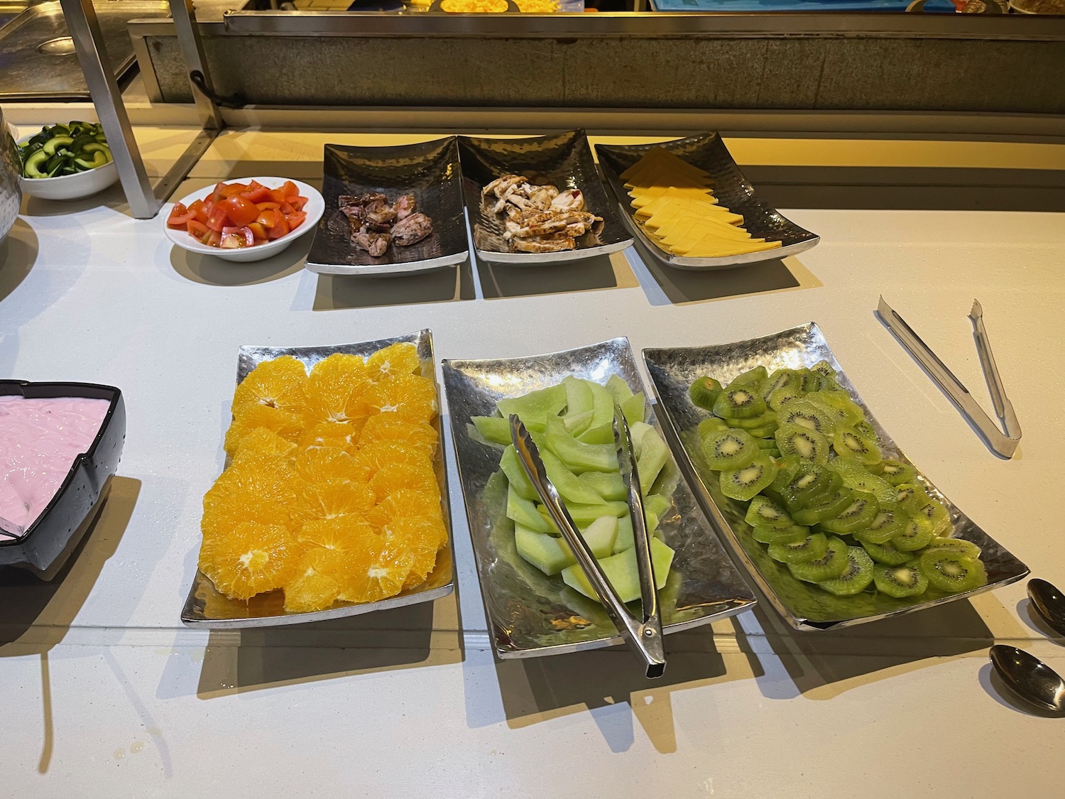 a table with plates of fruit and vegetables