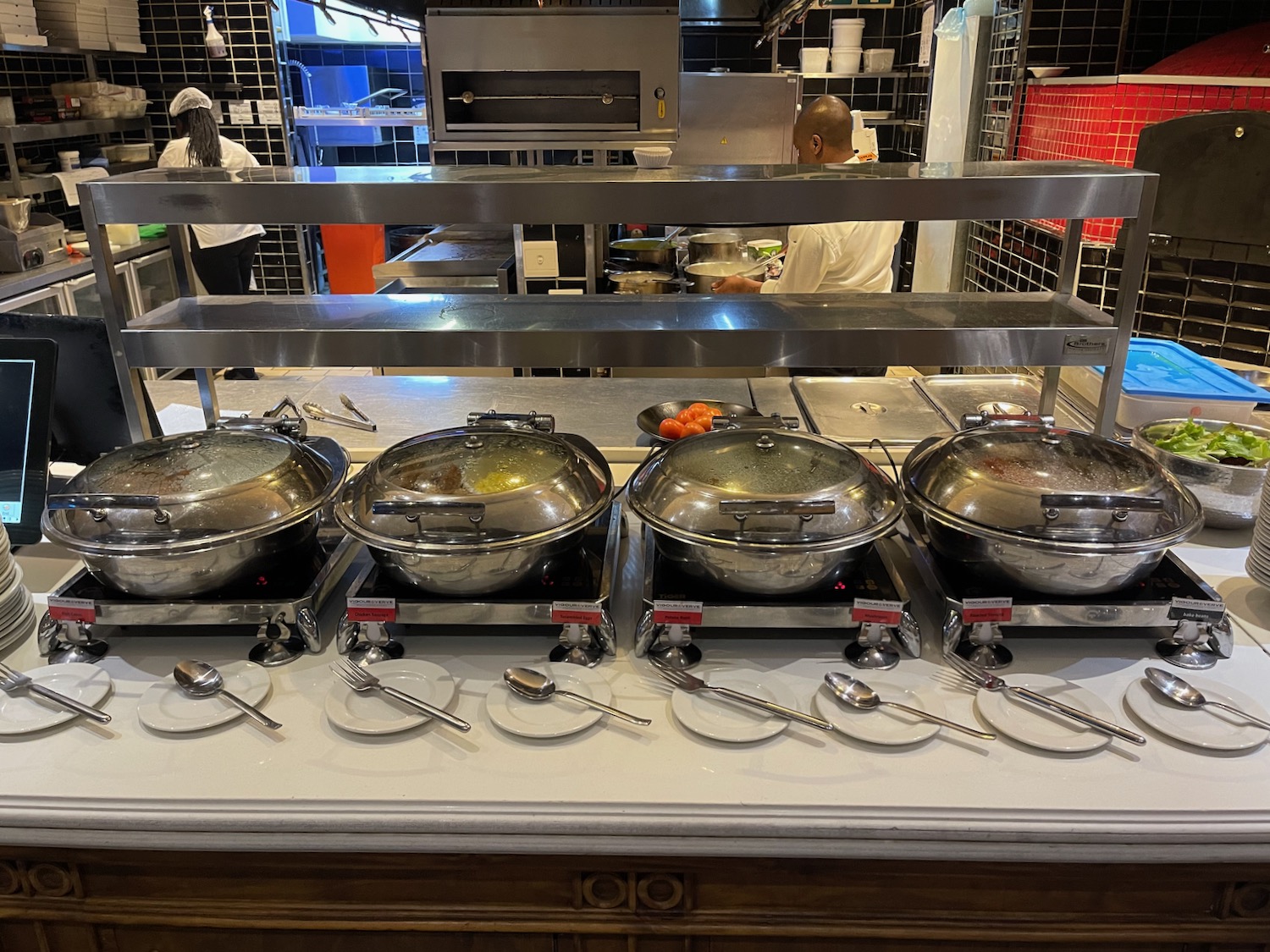 a row of stainless steel pots on a counter