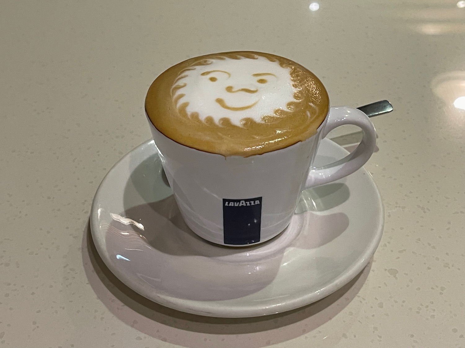 a cup of coffee with a face on the foam
