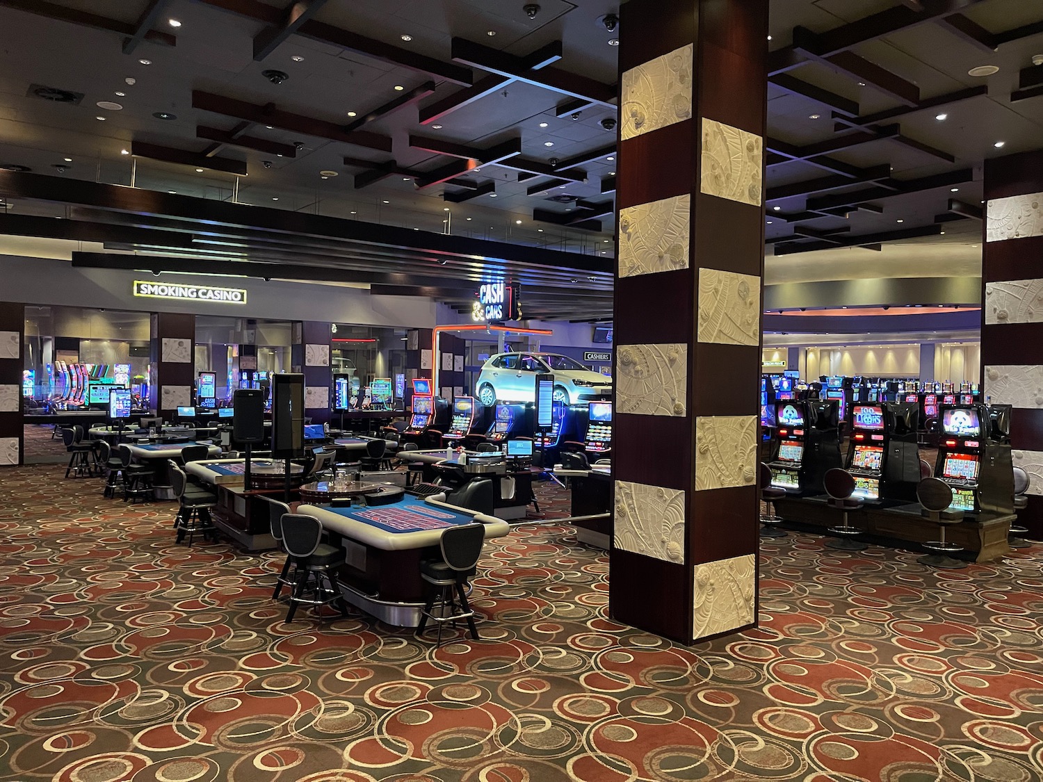 a room with gaming machines and a column