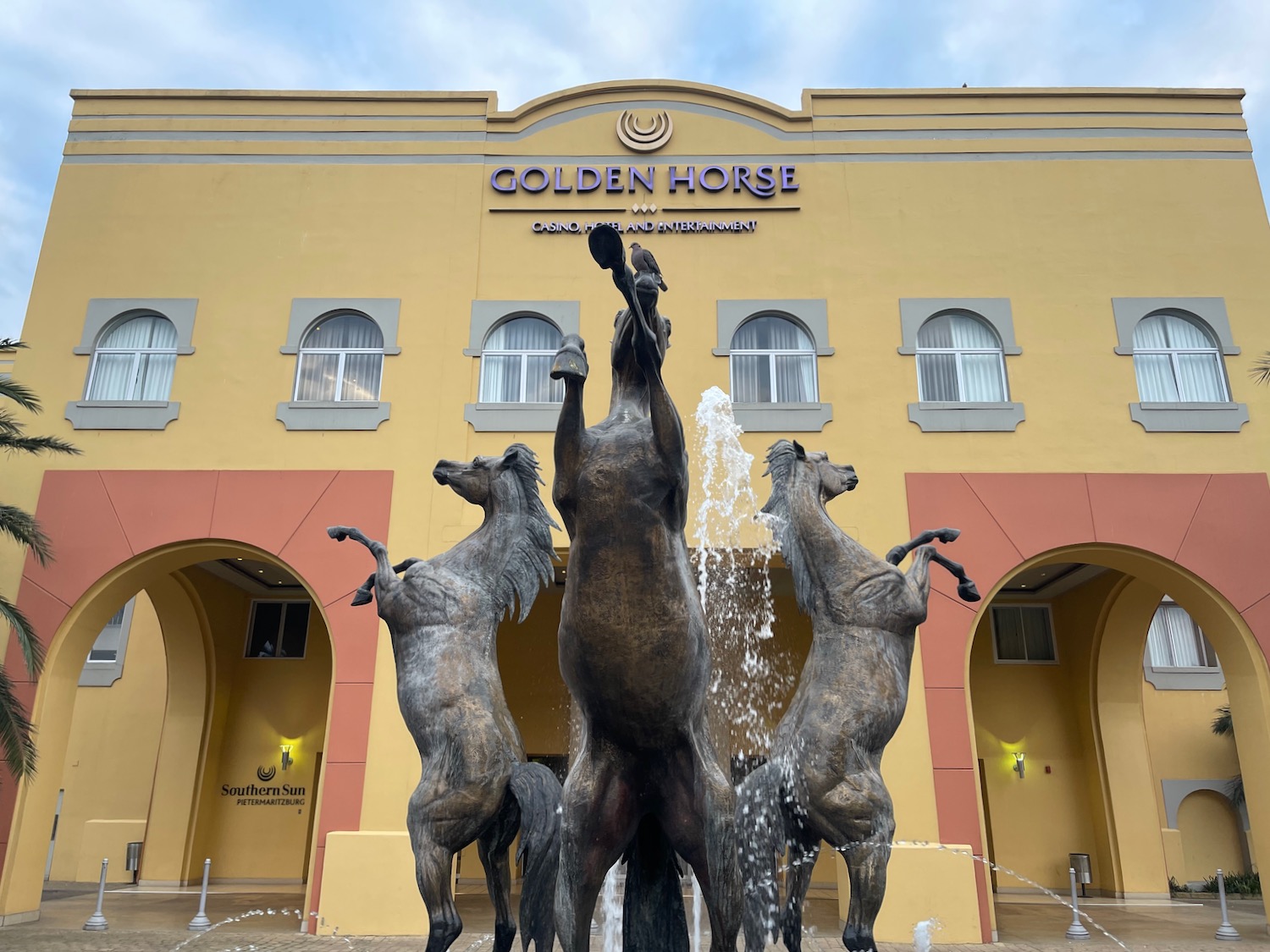 a statue of horses in front of a building
