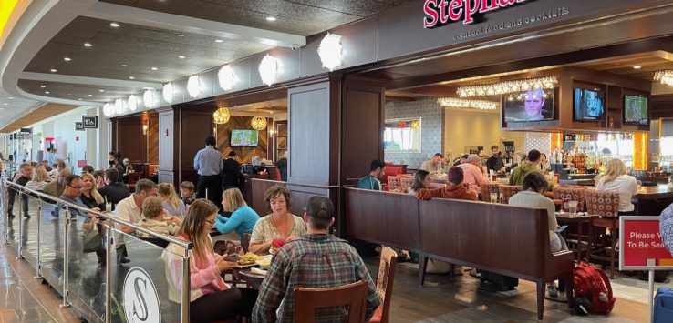 a group of people sitting at tables in a restaurant