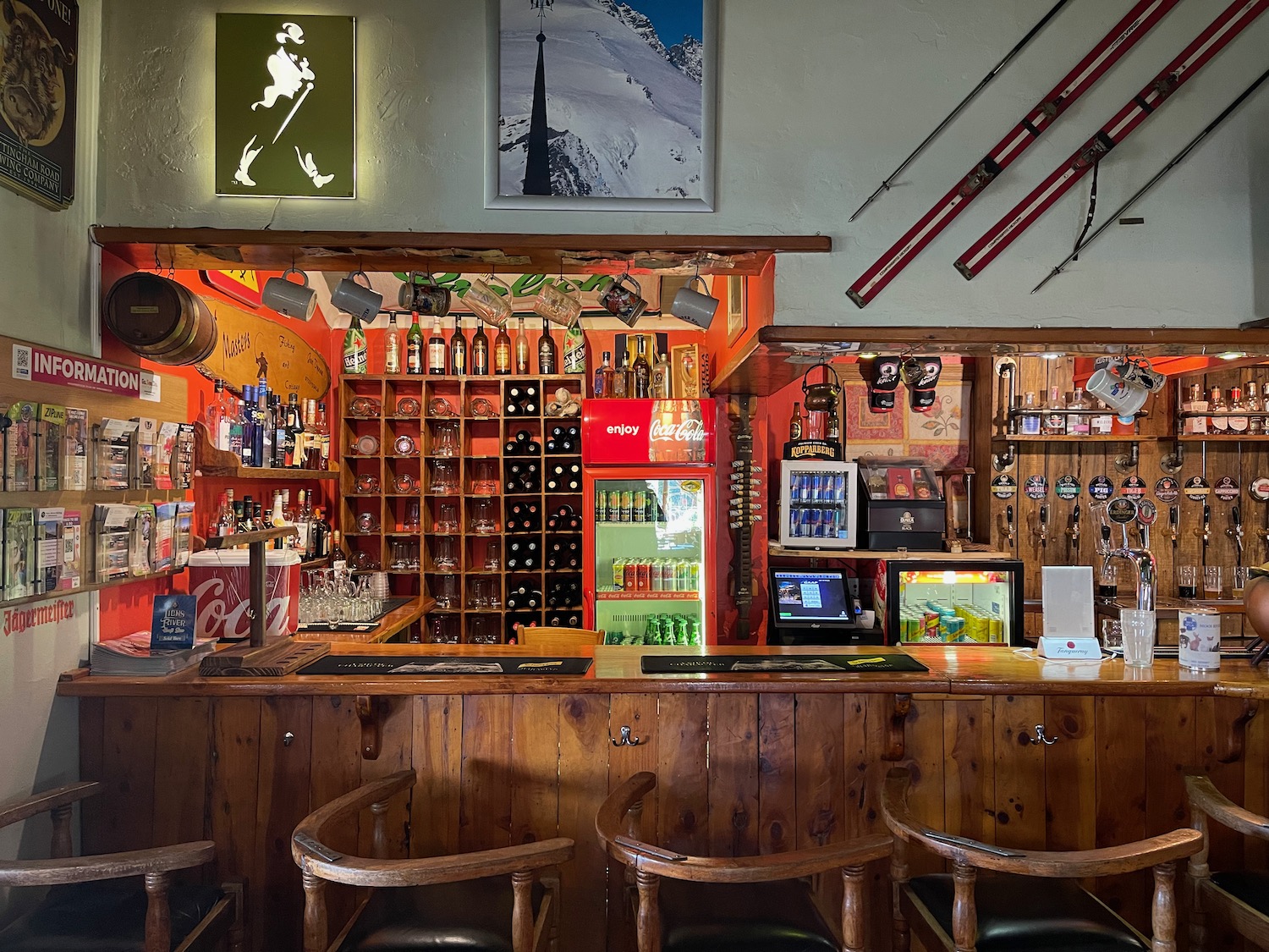 a bar with shelves and bottles of alcohol