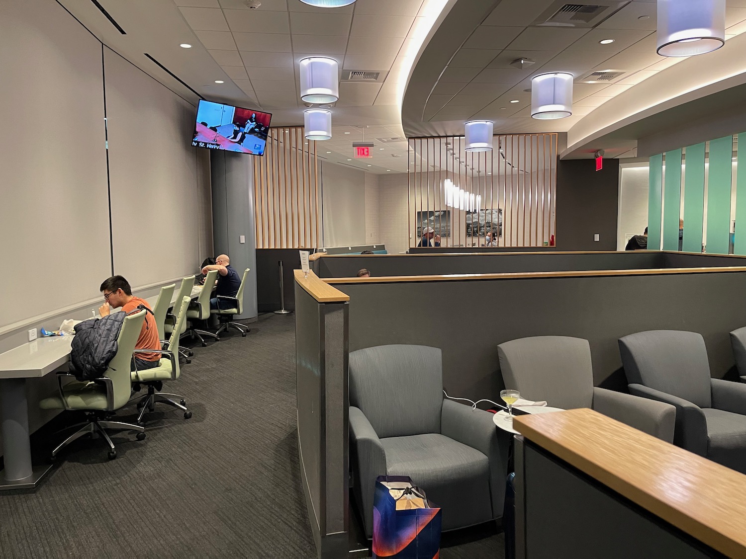 a room with a television and people sitting in chairs