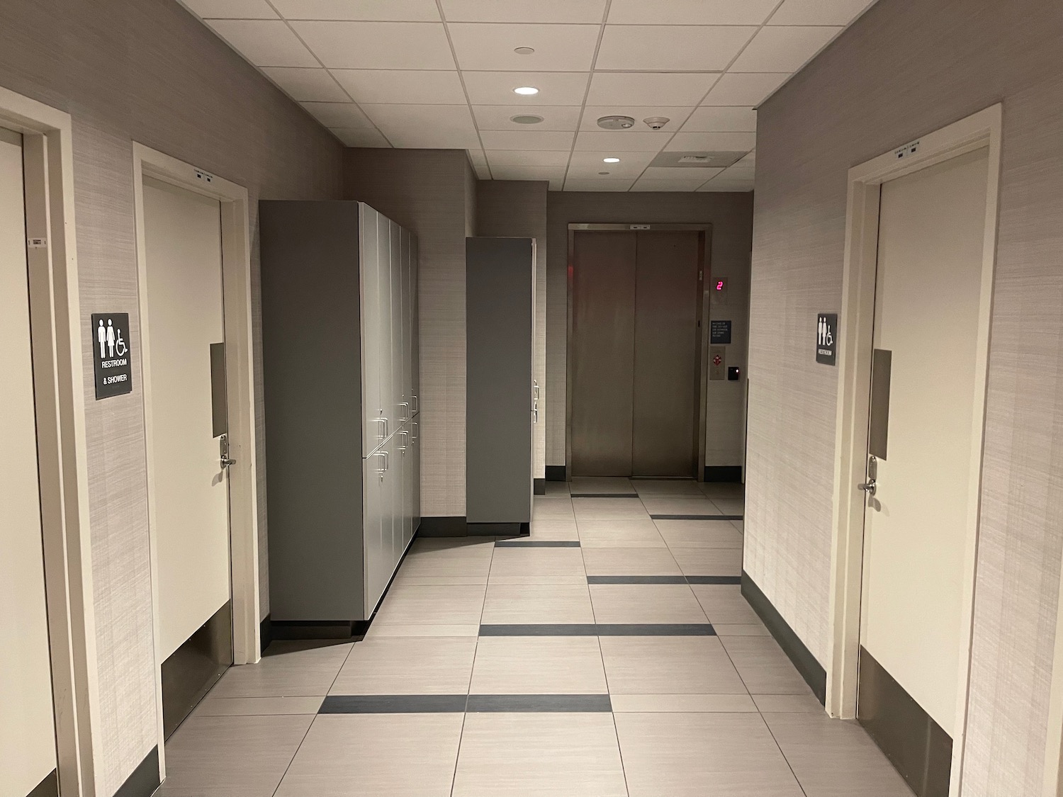 a hallway with lockers and doors