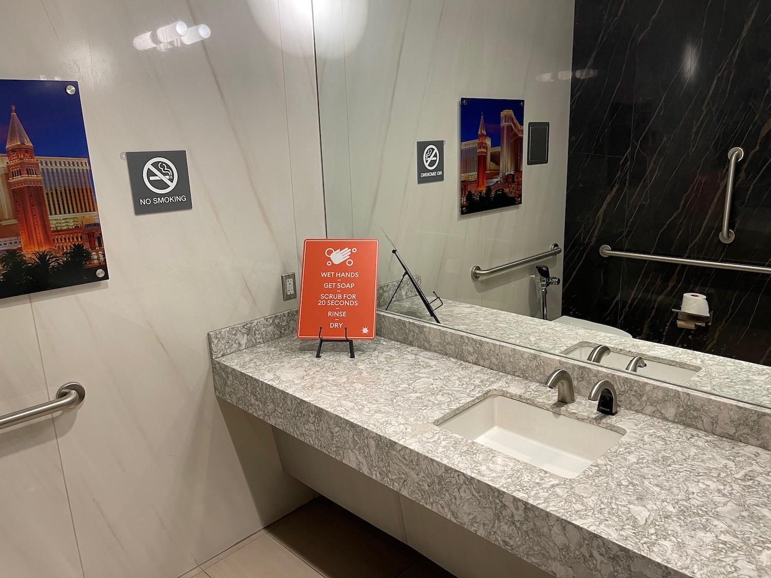 a bathroom with a sink and a sign