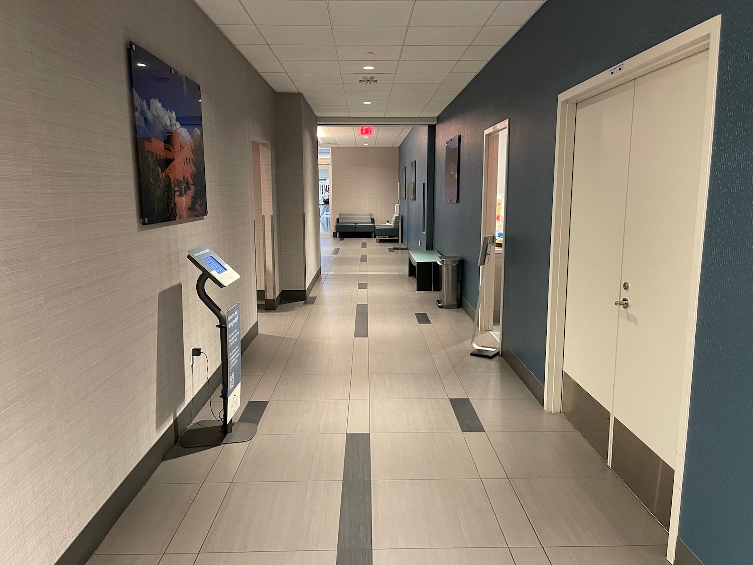 a hallway with a white and blue wall and a white door