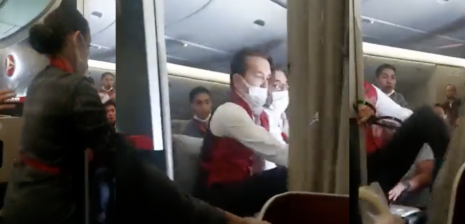 a man wearing a mask and sitting on a plane