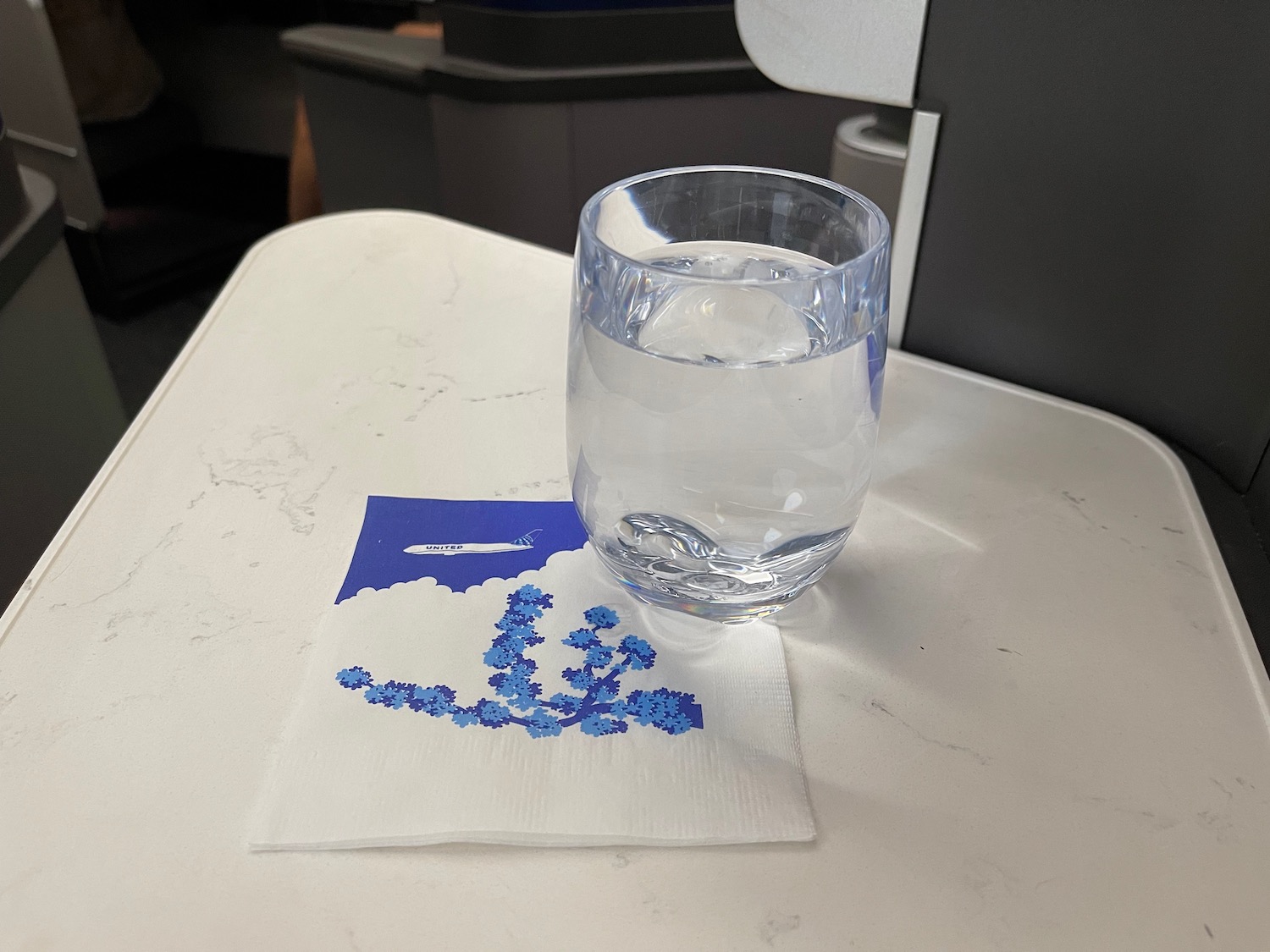 a glass of water on a napkin