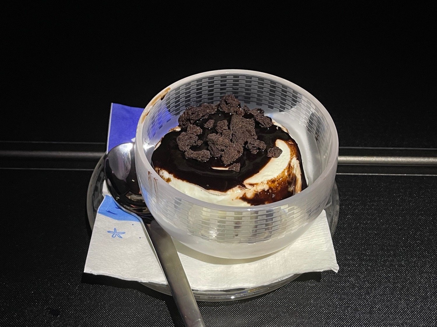 a dessert in a plastic container with a spoon