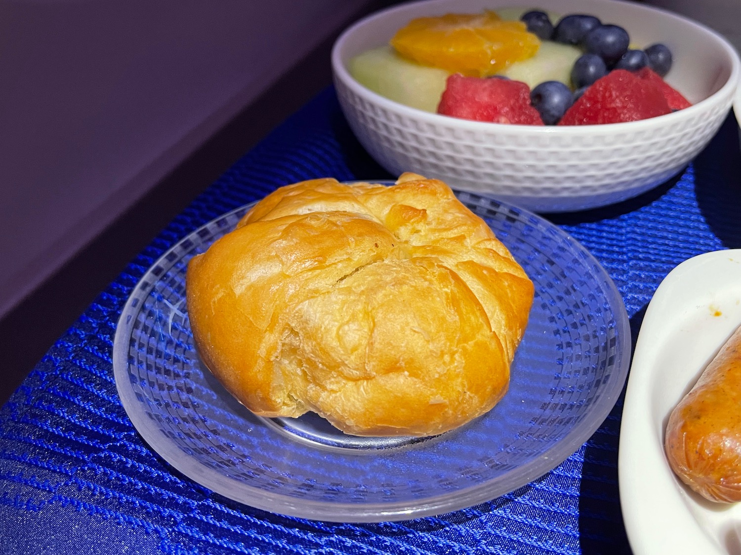 a plate of food and a bowl of fruit