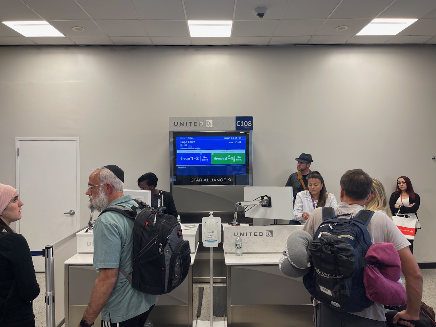 a group of people in a room with a computer screen