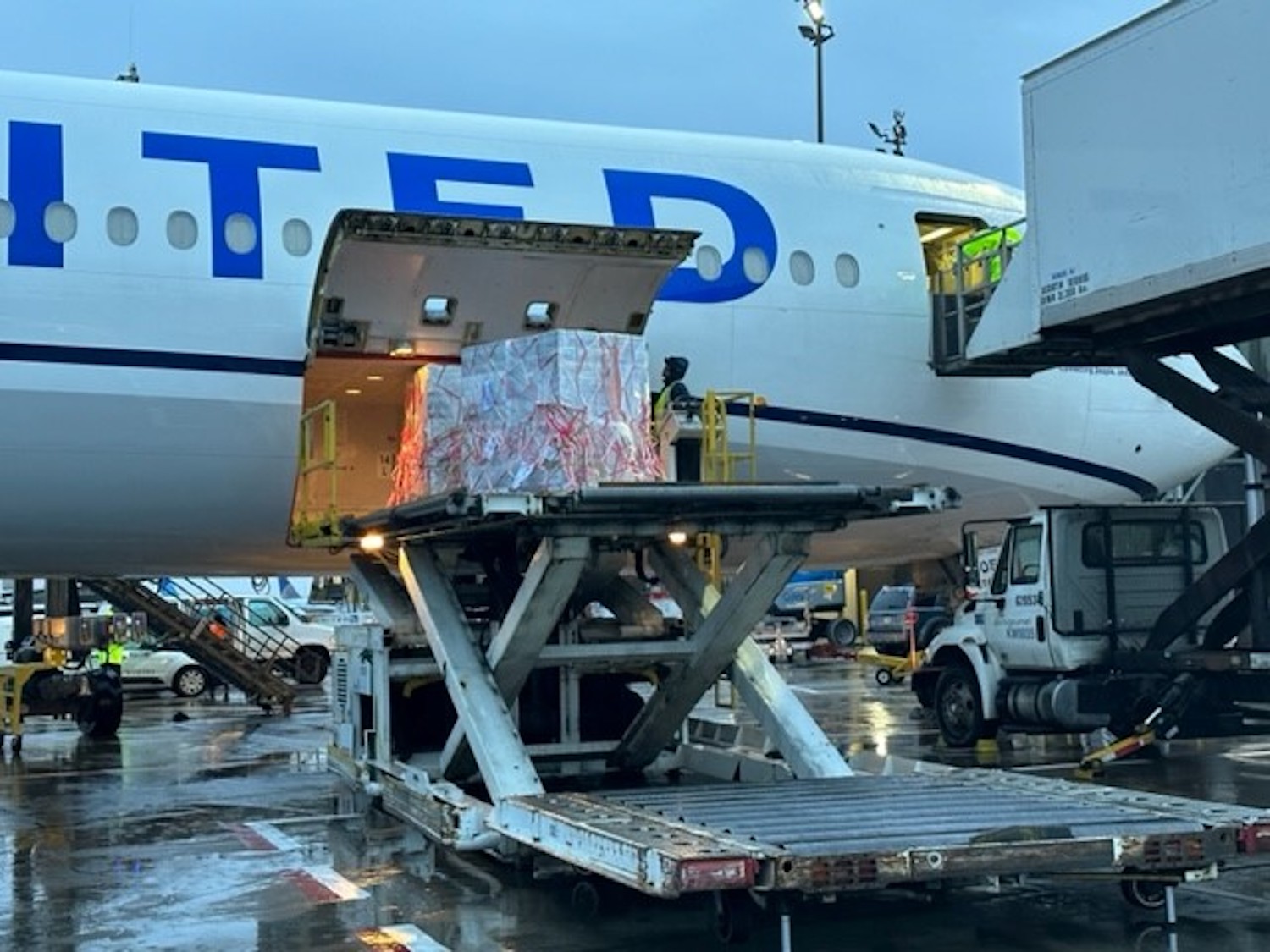 a large white airplane with a large load on it