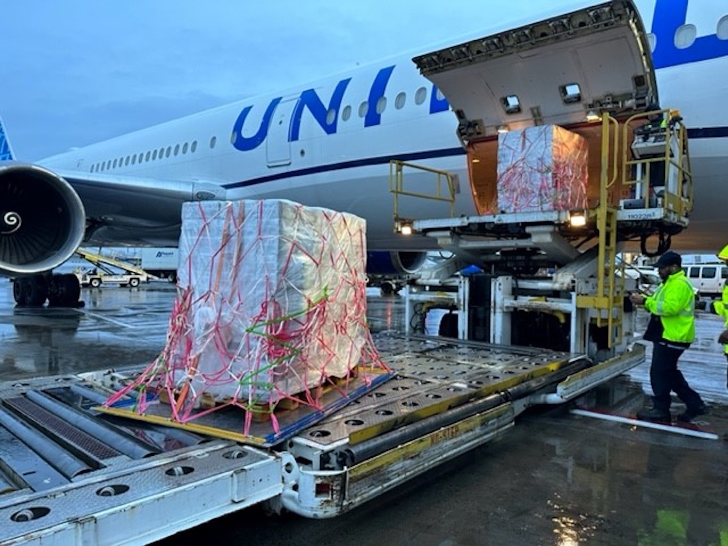 a large white airplane with a large white box on it