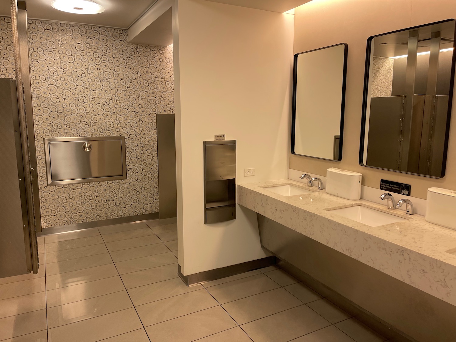 a bathroom with sinks and mirrors