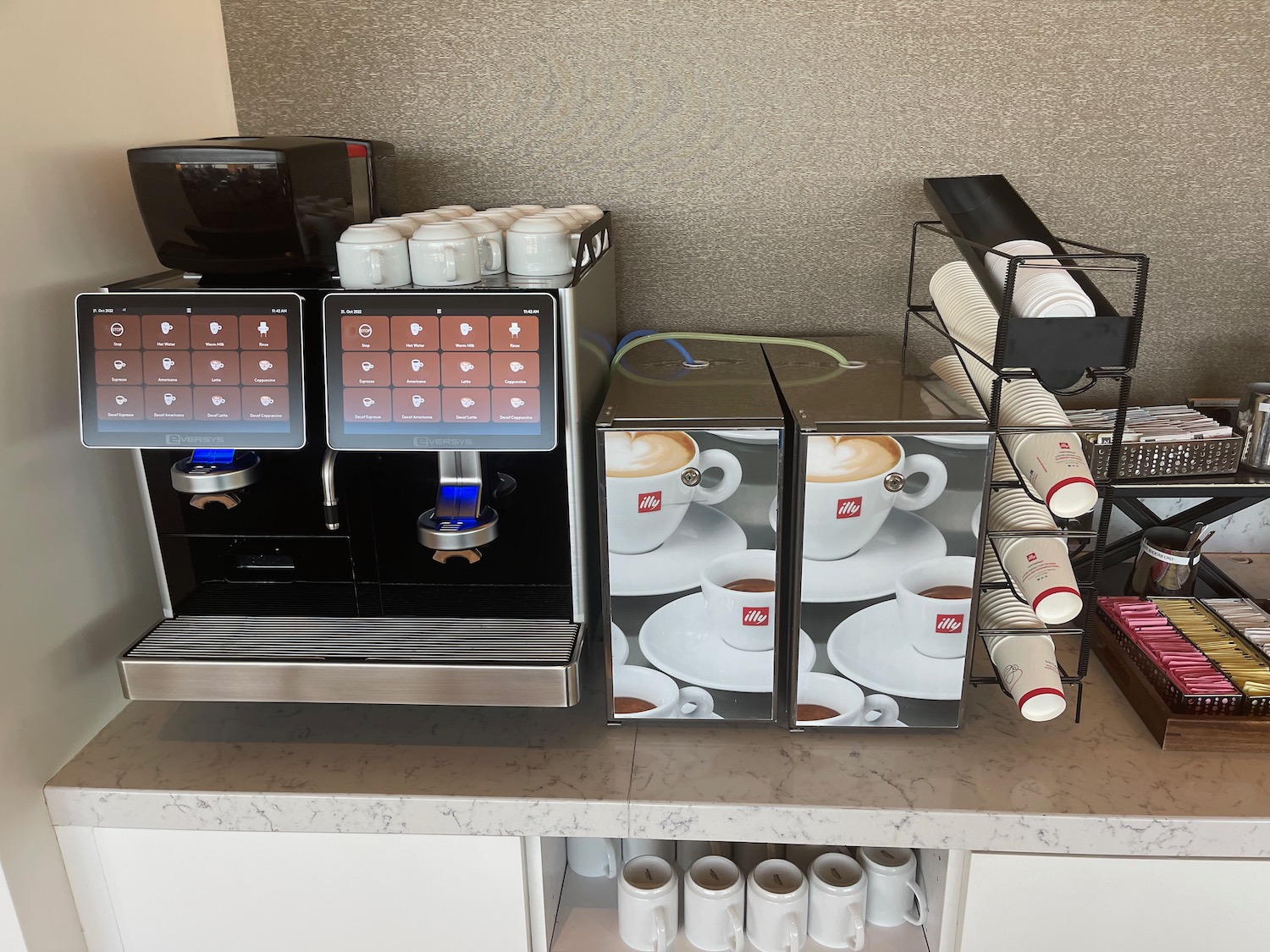 a coffee machine and cups on a counter