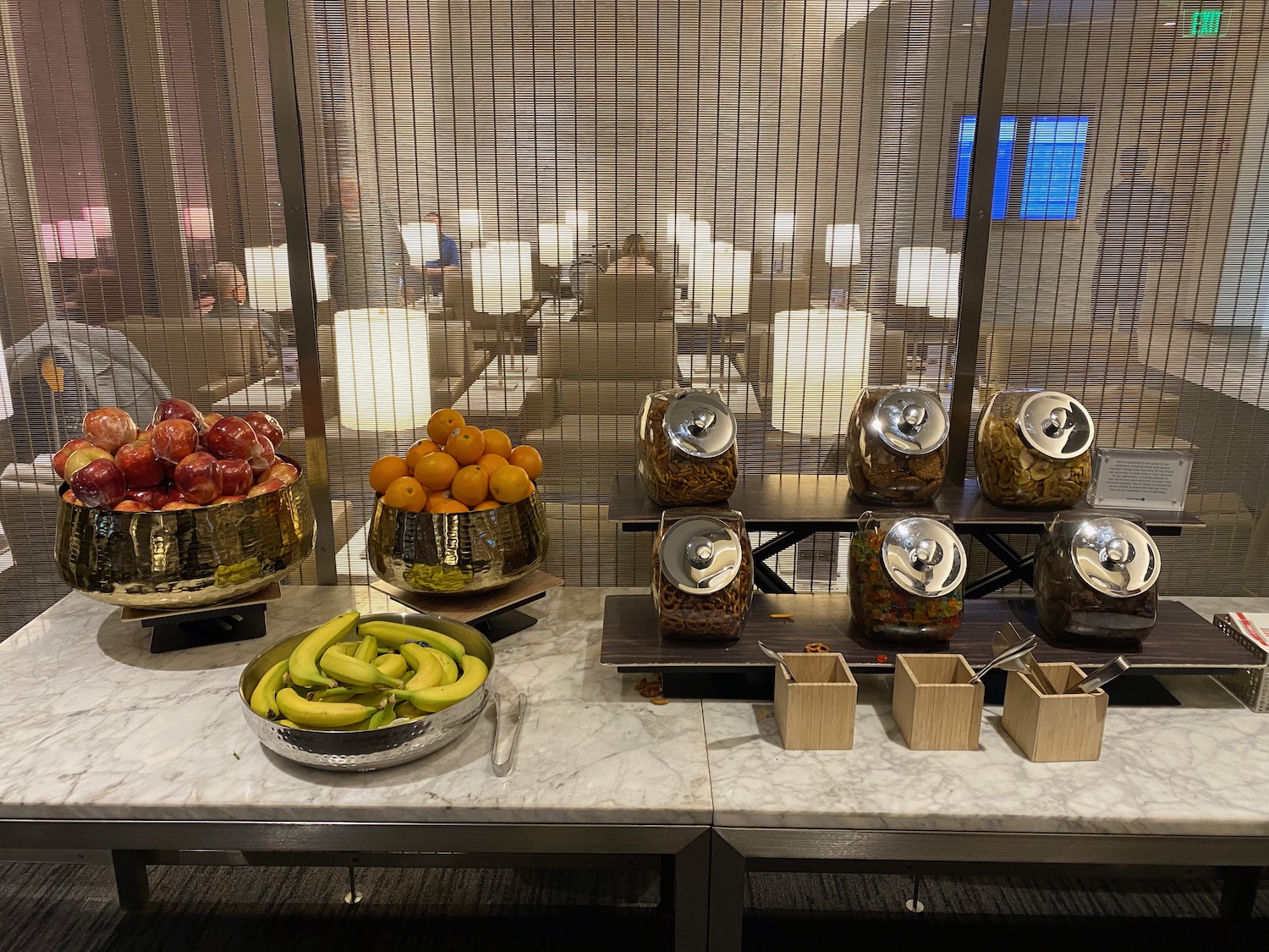 a buffet table with fruit and bowls of food