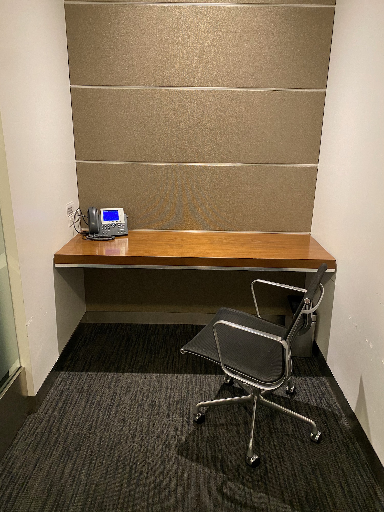 a desk with a telephone and a chair