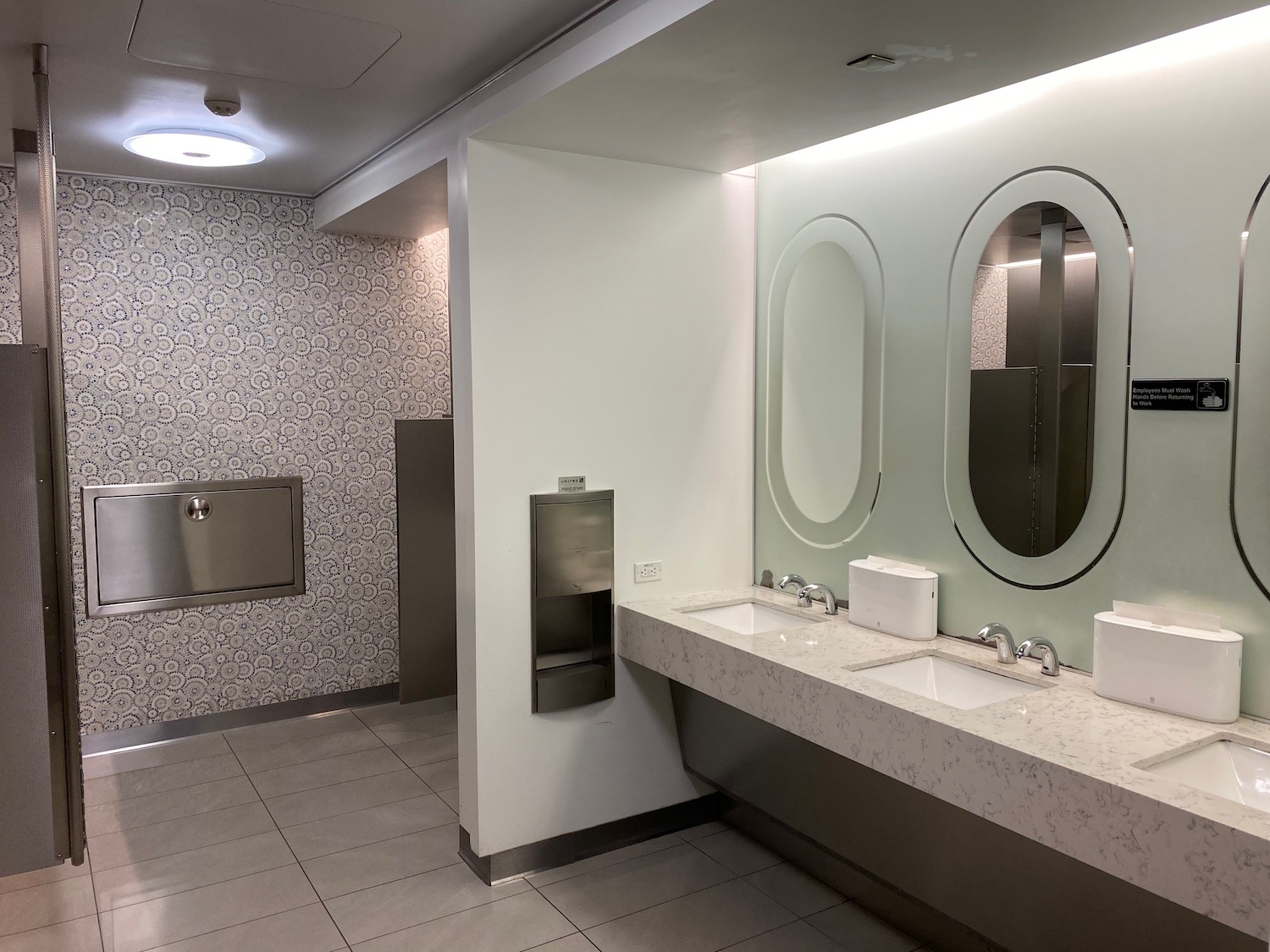 a bathroom with sinks and mirrors