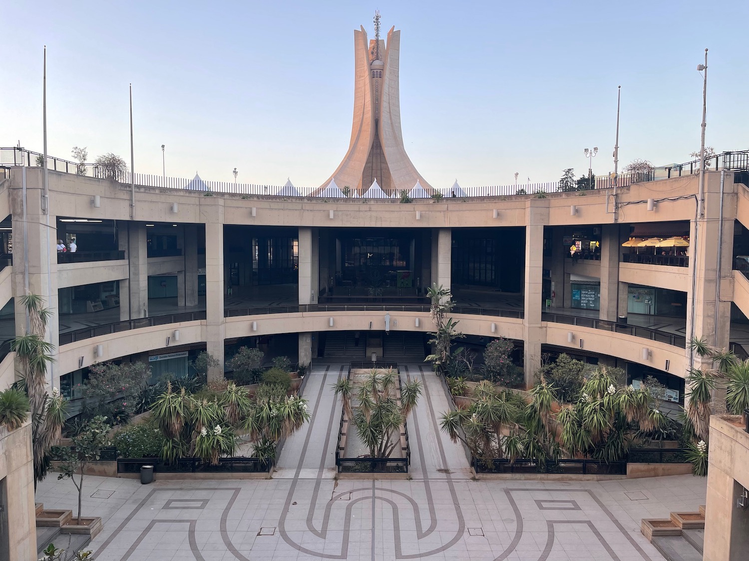 a building with a tower and plants