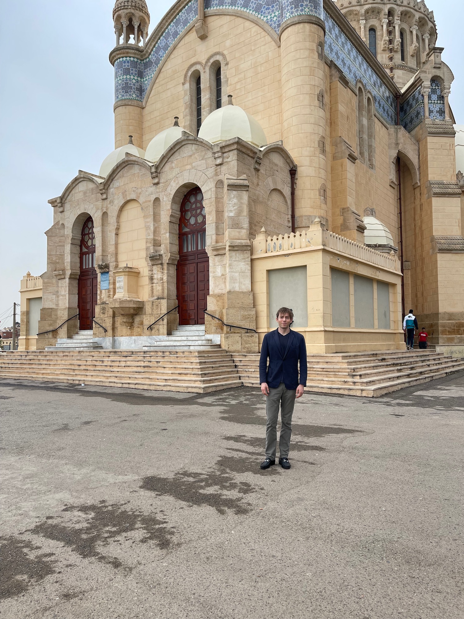 a man standing in front of a building