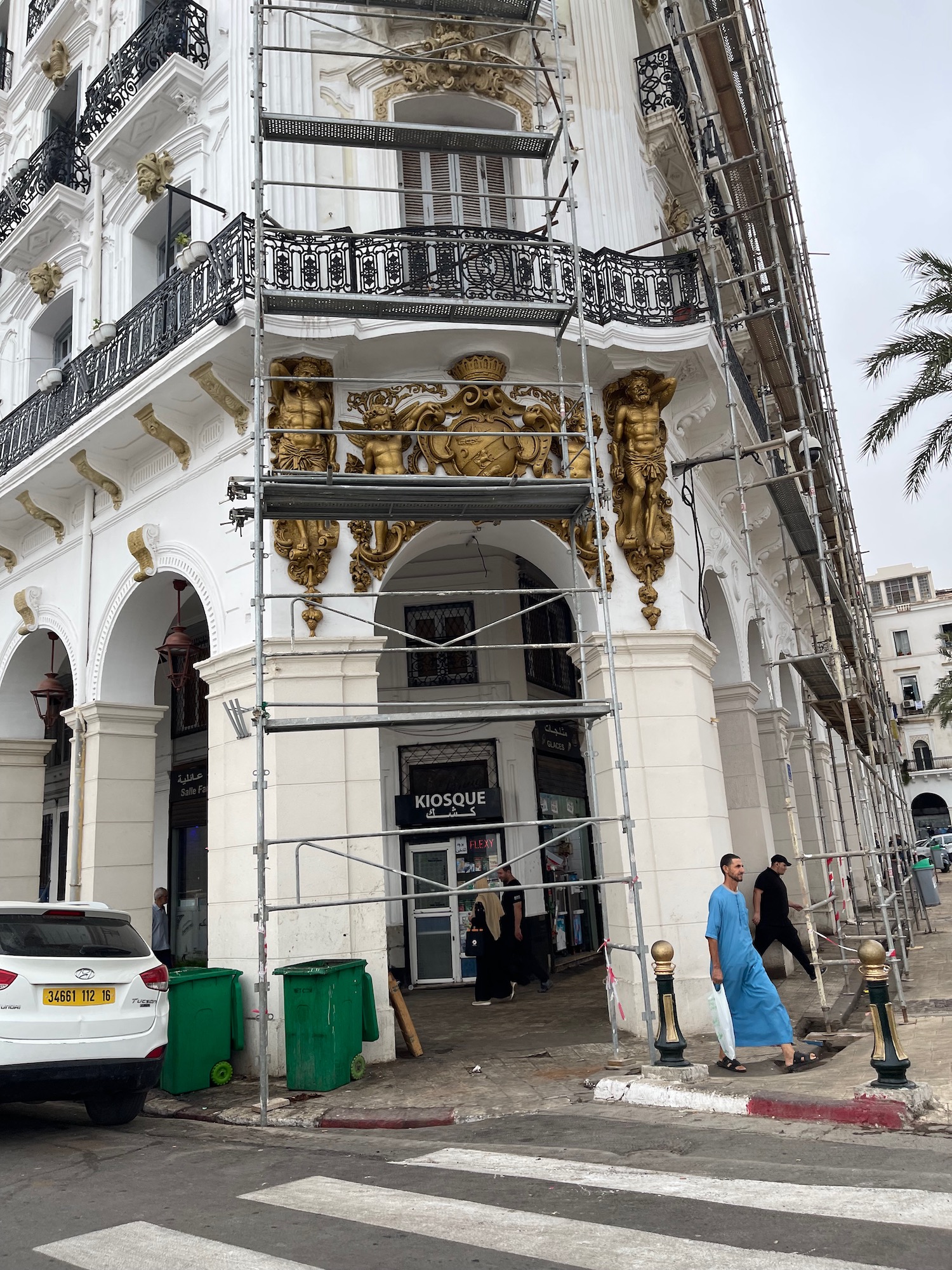 a building with scaffolding and people walking around