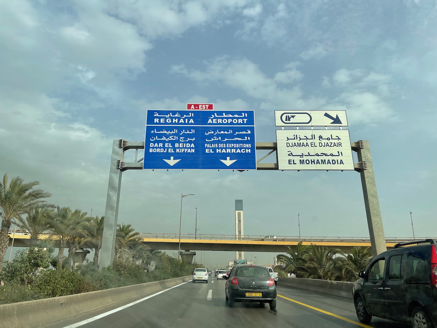 a road with signs and cars on it