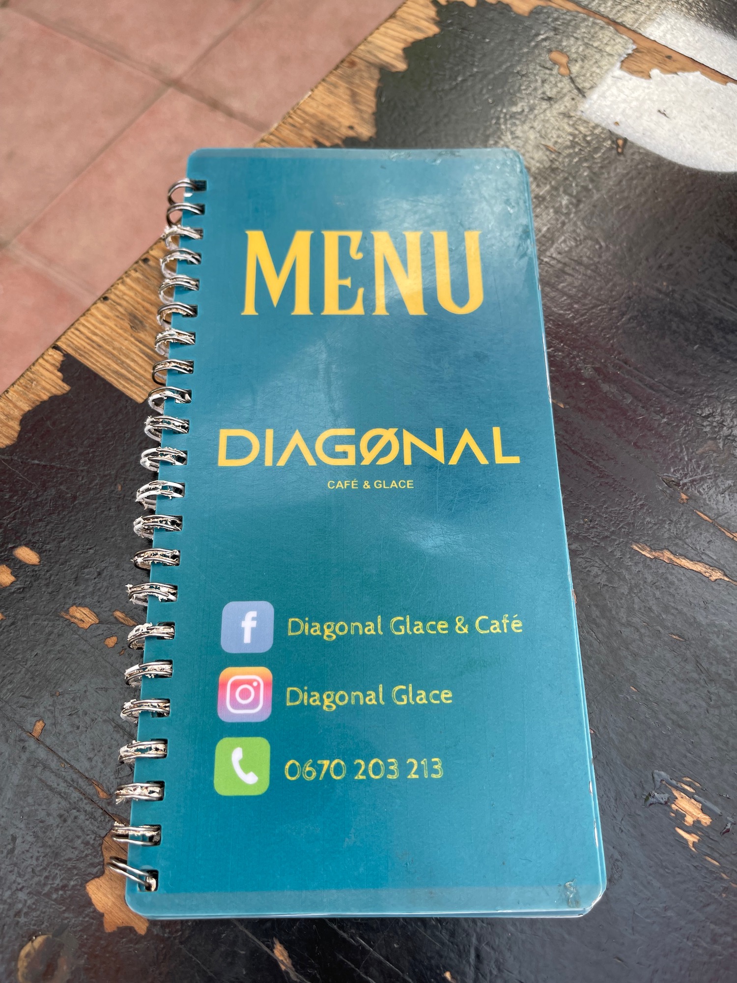 a blue menu on a spiral bound notebook