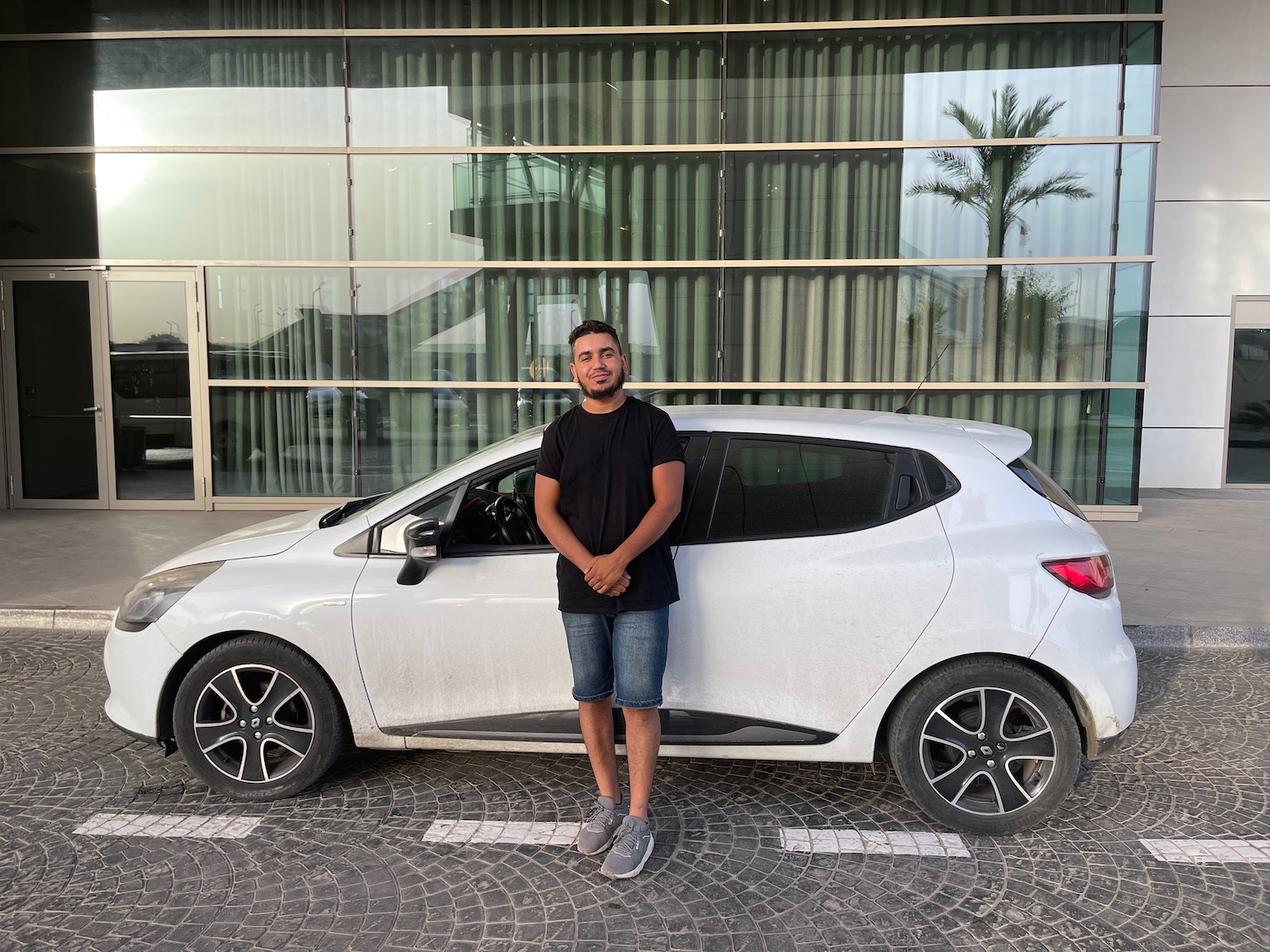 a man standing next to a car