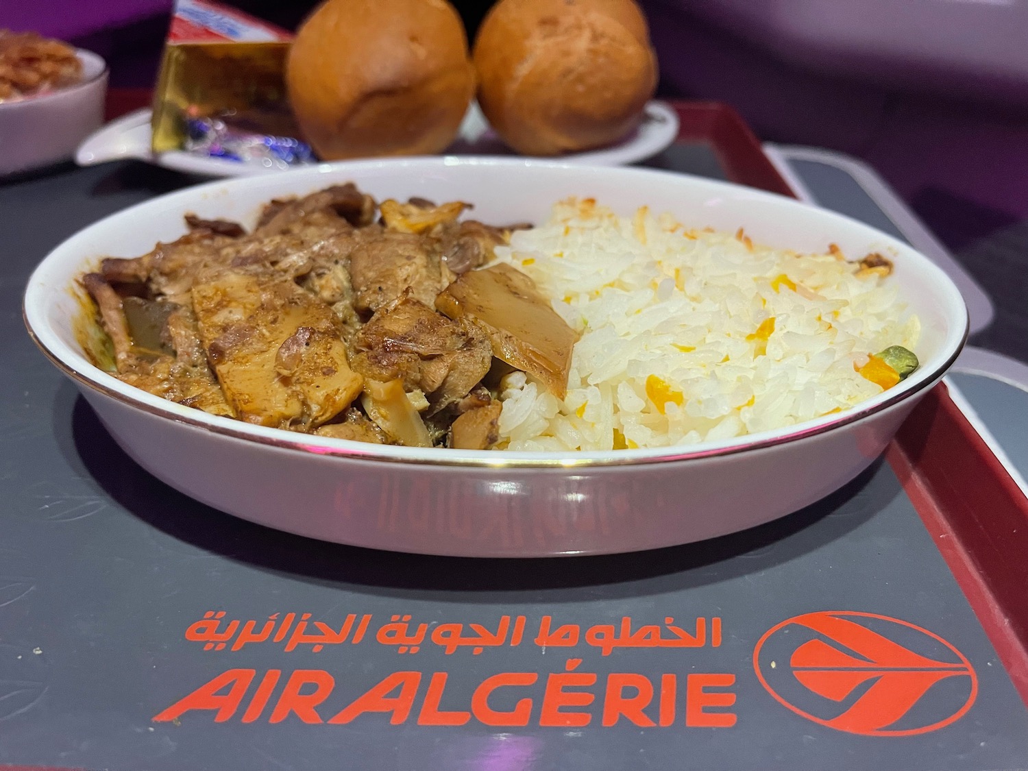 a bowl of rice and meat on a tray