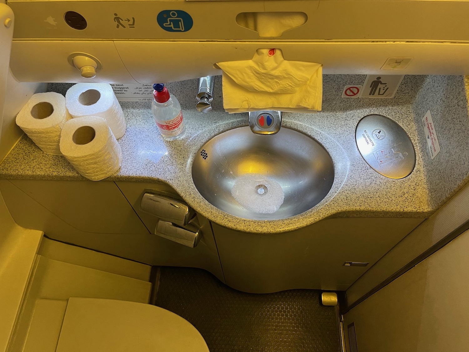 a sink and toilet paper on a counter