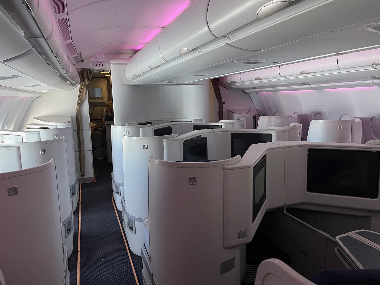 a white airplane with a pink light