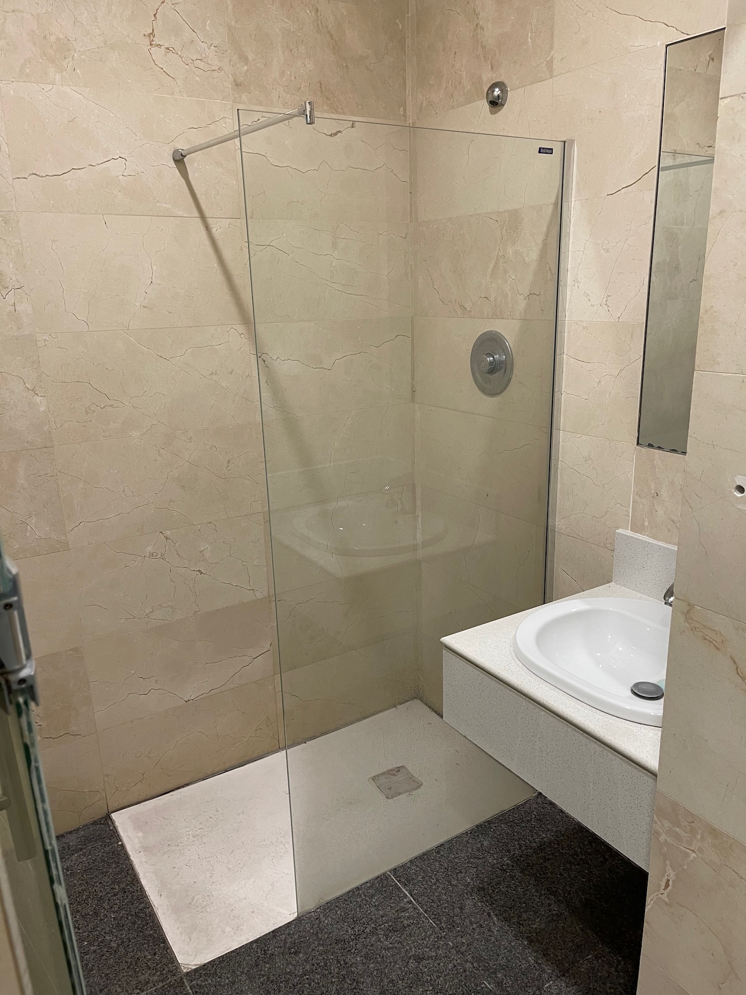 a bathroom with a glass shower door