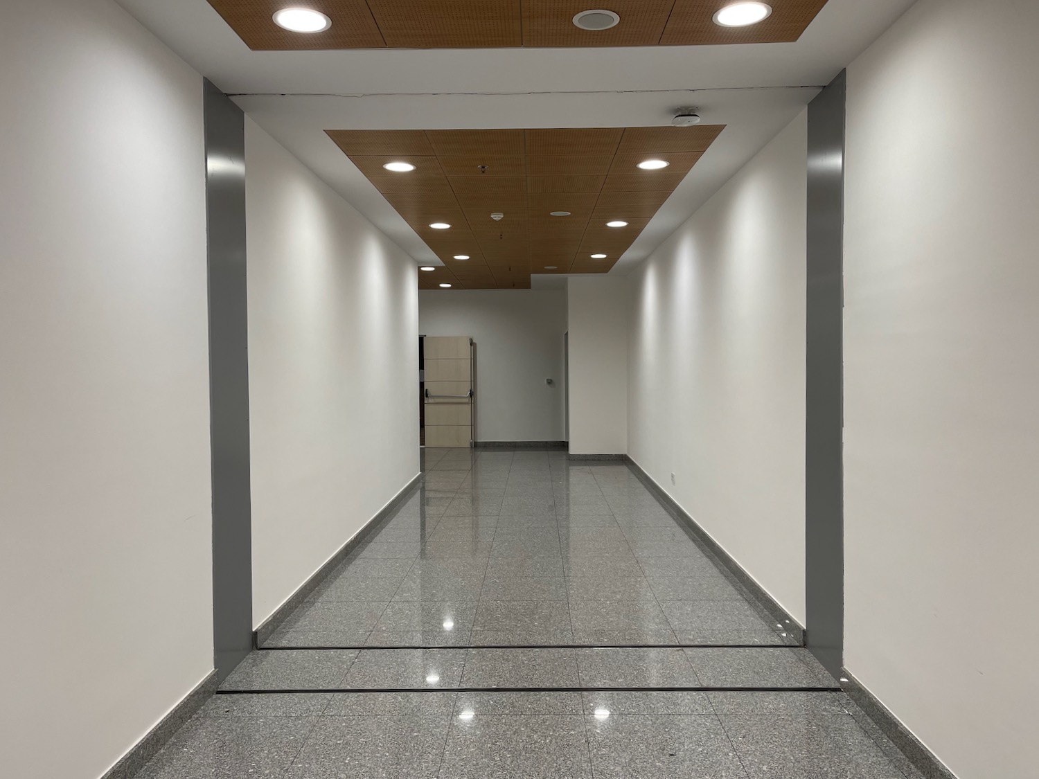 a hallway with lights on the ceiling