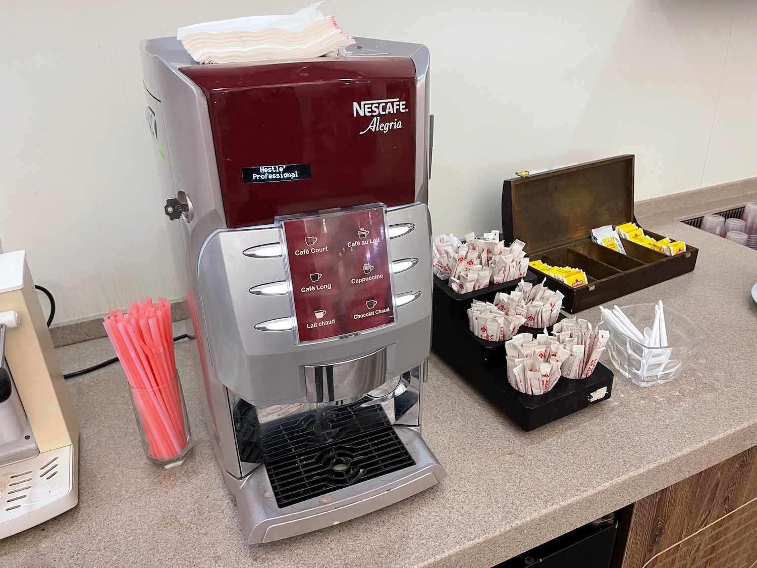 a coffee machine and sugar packets on a counter