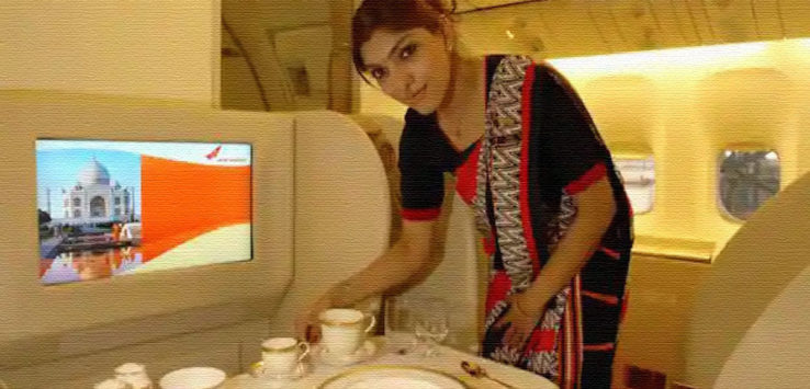 a woman standing in front of a table with a television