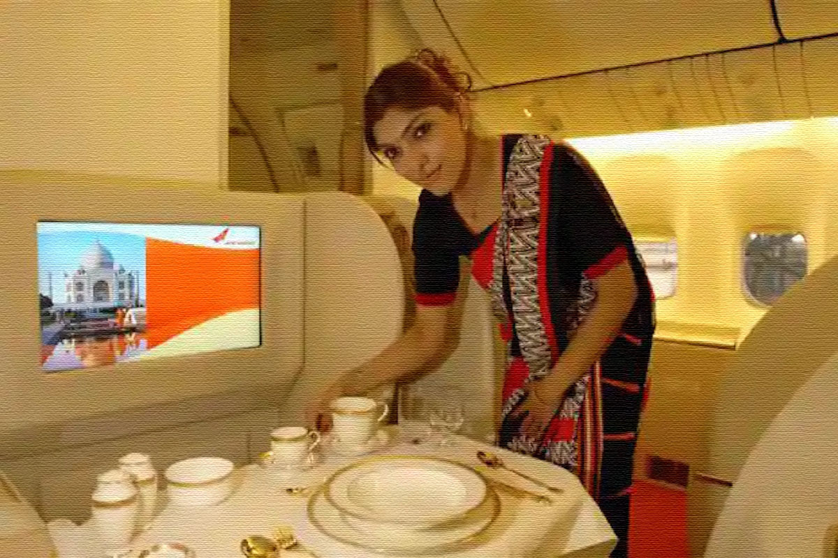 a woman standing in front of a table with a television