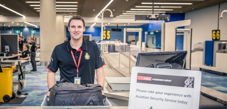 a man holding luggage in a airport